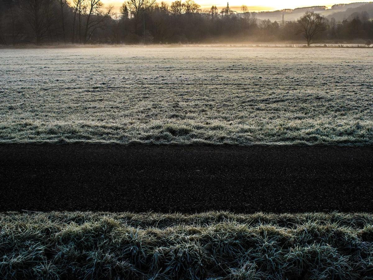 Snow-capped peaks reflected in a still mountain lake at dawn
